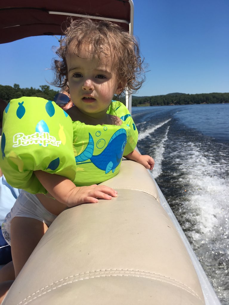 A cute toddler wearing a life jacket